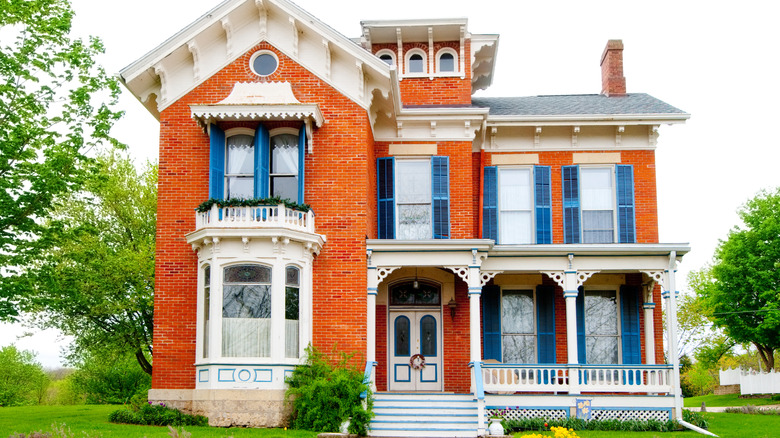Ornate Victorian home with bright blue shutters