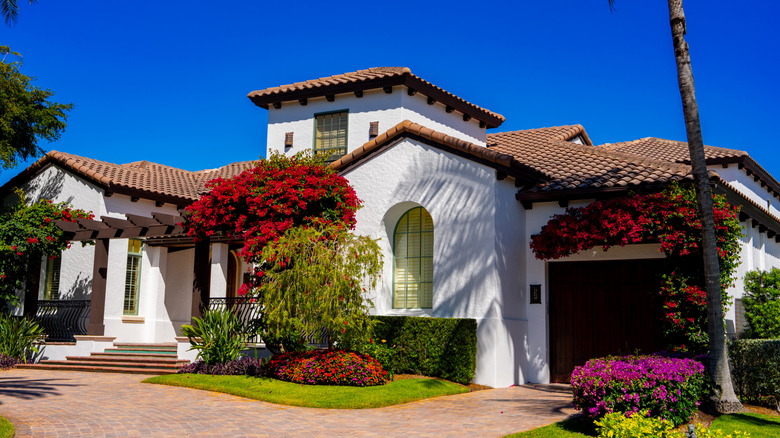 Tuscan style home with terra cotta roof and stucco exterior