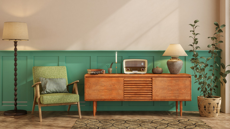 A mid-century modern designed living space with a chair and a sideboard