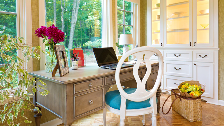 A desk facing a window in a home office