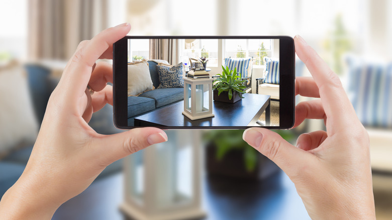 A person taking a photo of their interiors