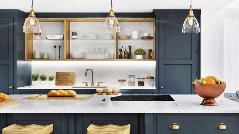A kitchen with shiny, gold details