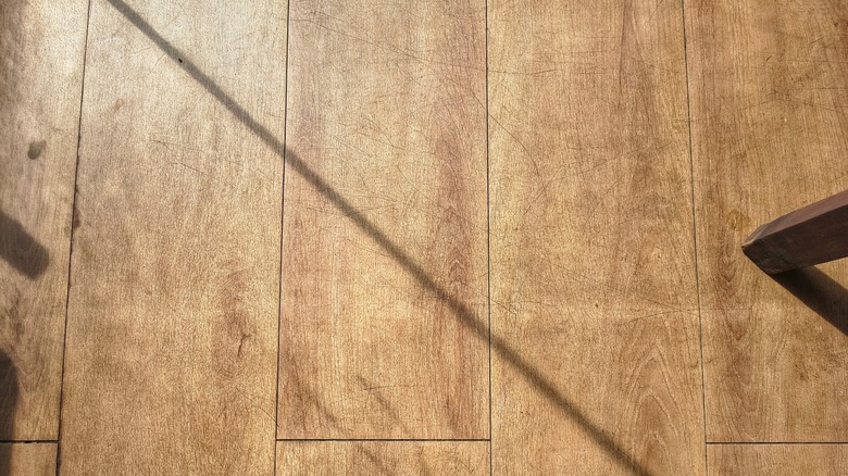 Sunlit wood floors with scratches
