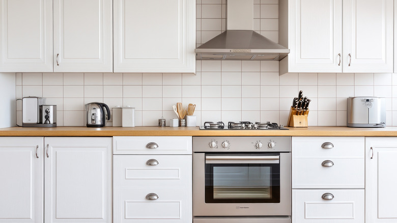 A kitchen with many cabinets