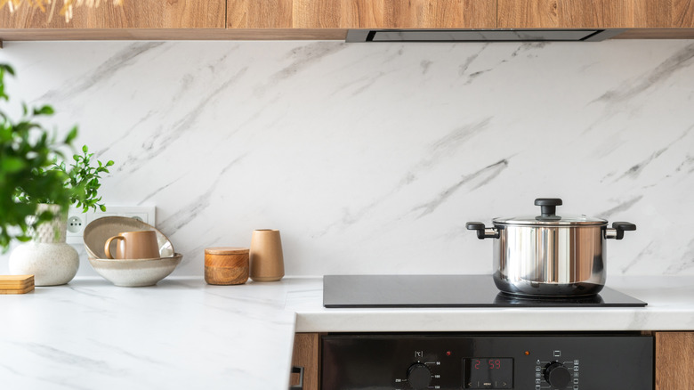 A kitchen with marble counters