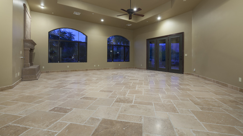 A large beige room with travertine flooring