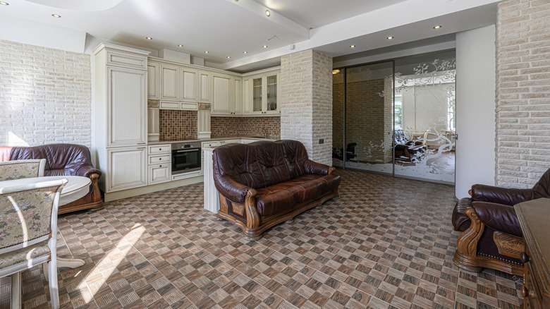 A living area with a unique, brown tile floor