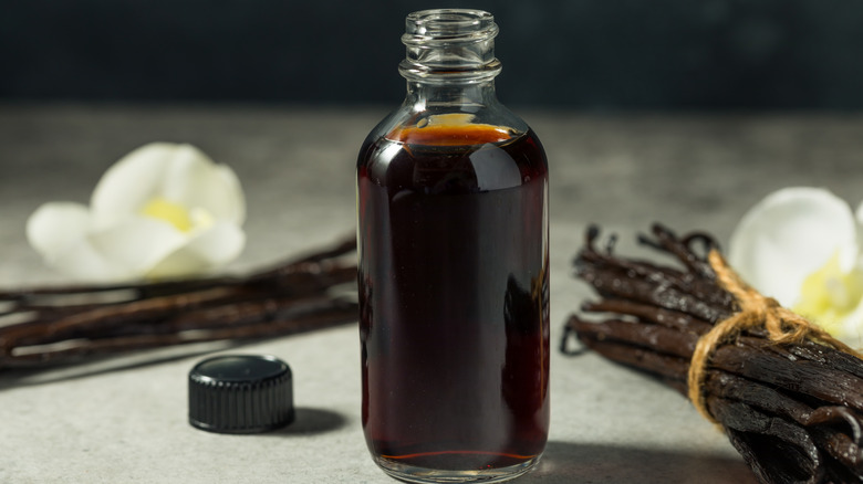 vanilla extract surrounded by vanilla beans