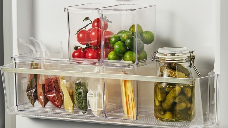 KLIPPKAKTUS Storage box set in fridge door with tomatos, limes, and spices inside