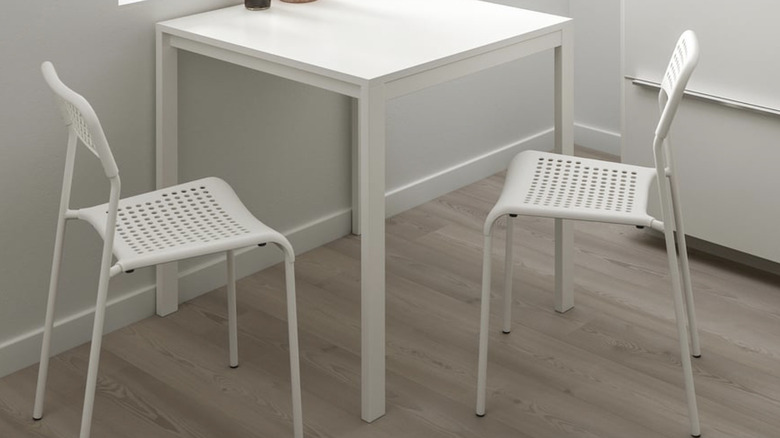 Two IKEA ADDE chair in white with a white table