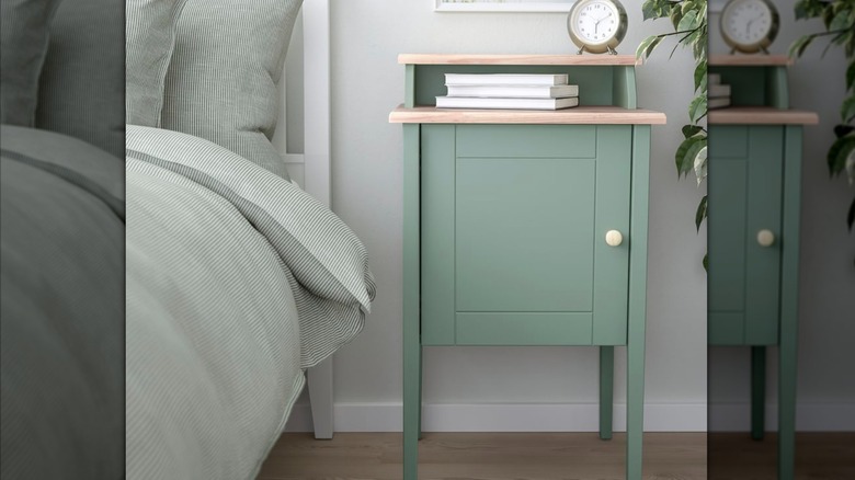 IKEA OLDERDALEN Nightstand in teal blue with books and a clock on top