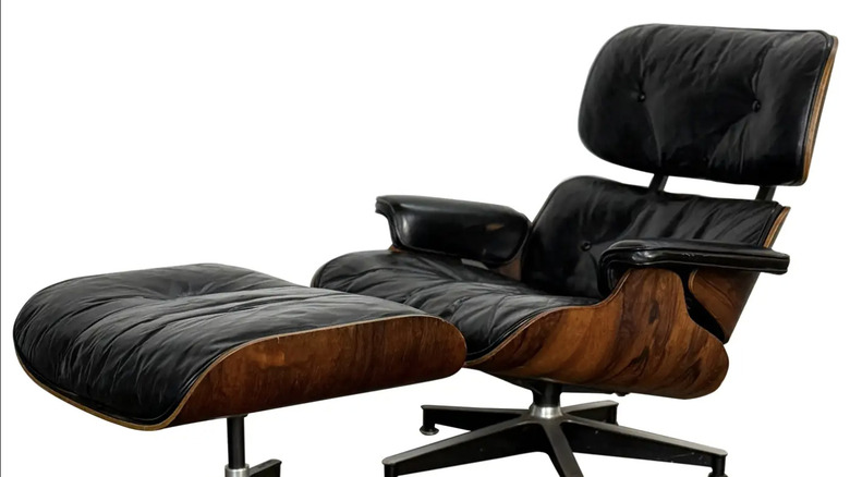 A 1960s original Early Herman Miller Eames lounge chair and ottoman on a white background
