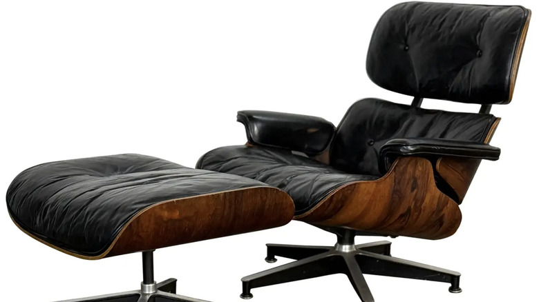 A 1960s original Early Herman Miller Eames lounge chair and ottoman on a white background