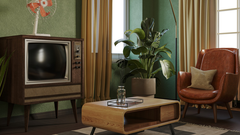 A cozy living room with a mid-century modern design and a vintage TV