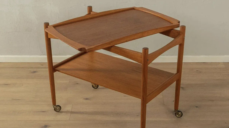 A teak rolling bar cart designed by Poul Hundevad