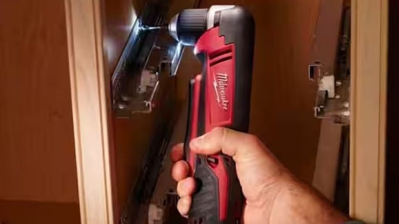 Person using right angle drill on beam