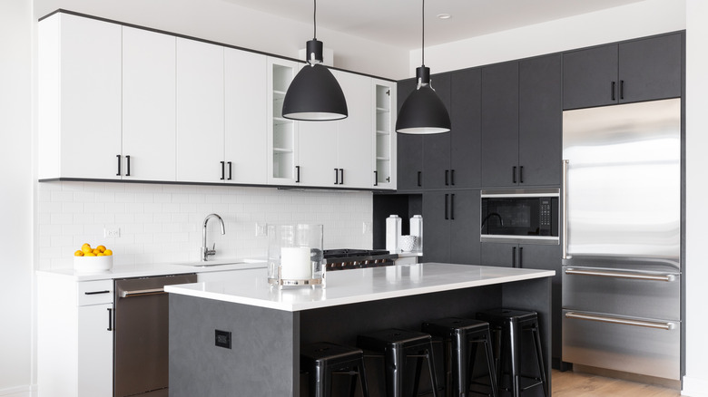 white and black kitchen with marble countertops