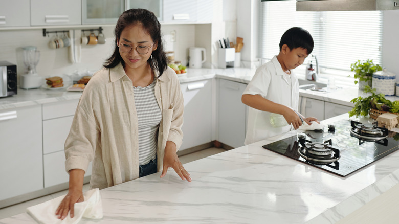Woman cleaning marple countertop