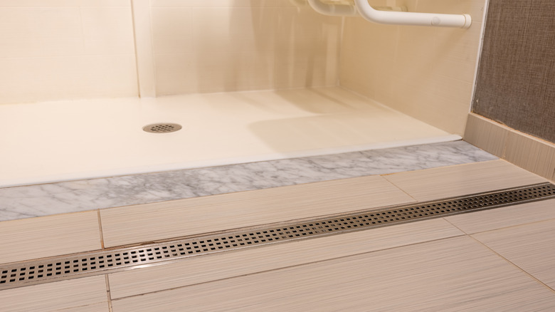 An open shower with a gentle slope so water runs in to the drain