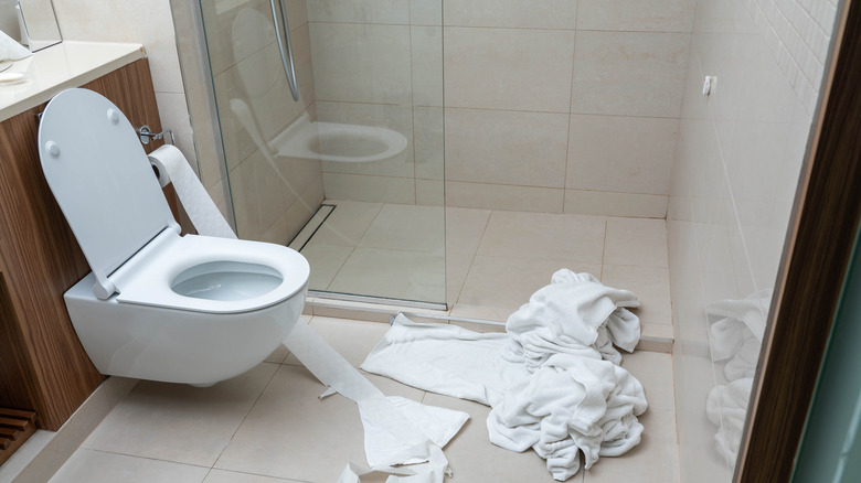 Towels being used to dry floor from the shower
