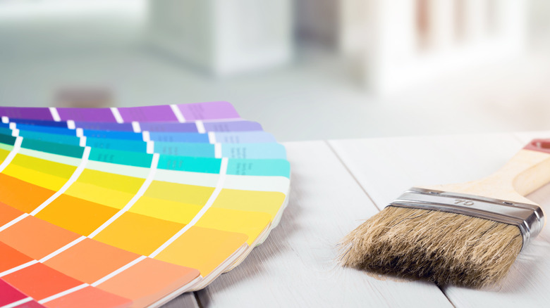 Paint swatches on a table with paint brush