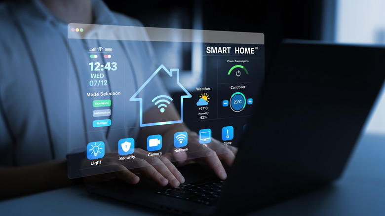 A person works on a laptop with a screen that says smart home