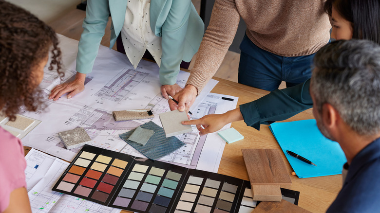 A group of people discussing materials for a design project