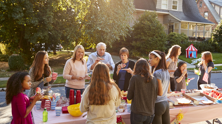 Neighbors eat around a table