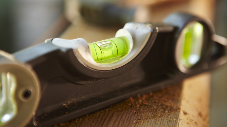A bubble level sits on a shelf