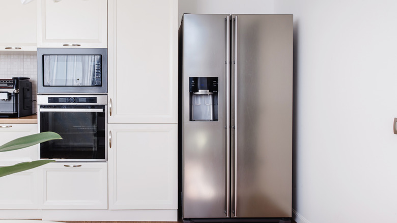 Modern kitchen with white cabinets and a French door refrigerator.