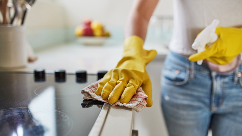 Woman wiping stovetop