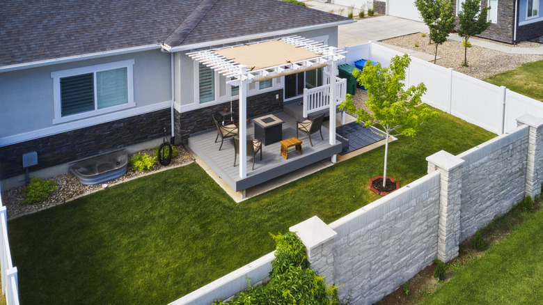 Aerial view of a small backyard patio with a well-fitted pergola