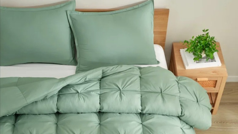 Costco's new 3-piece comforter set in green, set up on a bed for display.