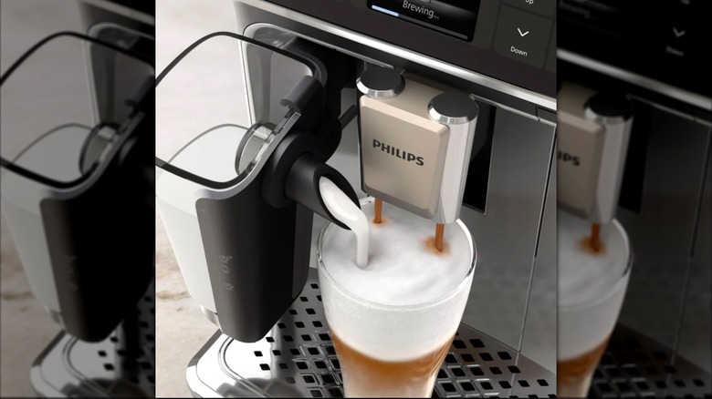 Auto coffee and espresso machine with frother sitting on kitchen counter.