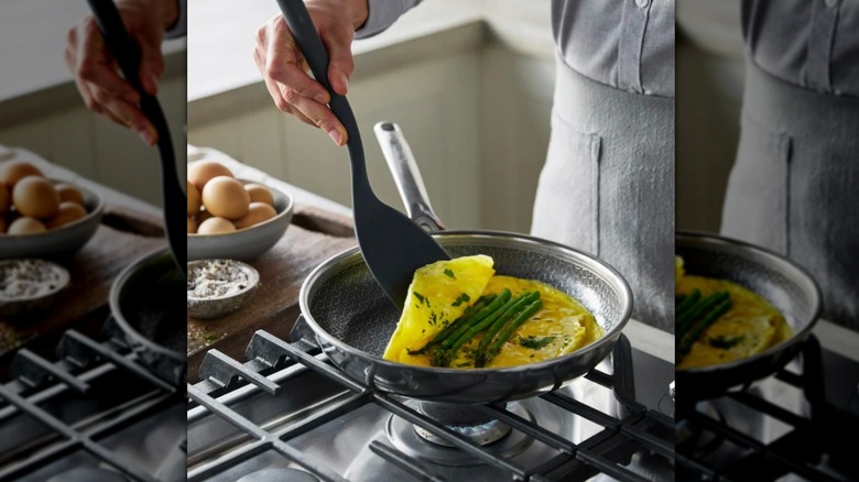 Person cooking breakfast using a frying pan from Costco's new selection.