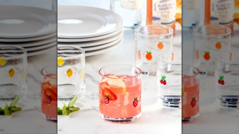 Set of four fruit icon glasses sitting out on a table.