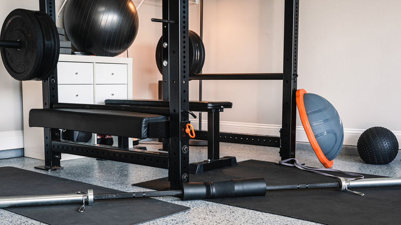 Home gym with weight lifting equipment, exercise balls, and mats