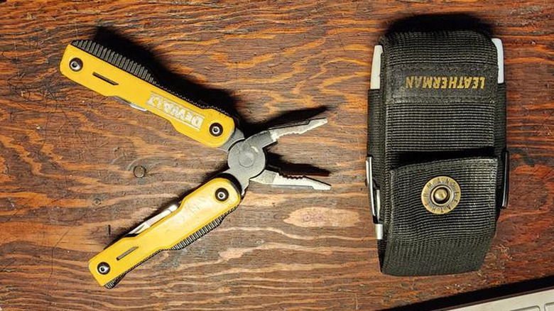 DeWalt multi-tool pliers beside fabric holder on wood surface