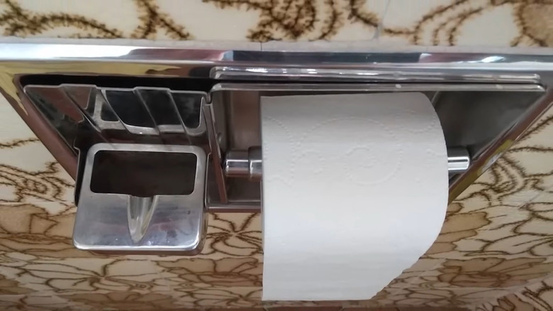 Built-in ashtray in bathroom next to the toilet