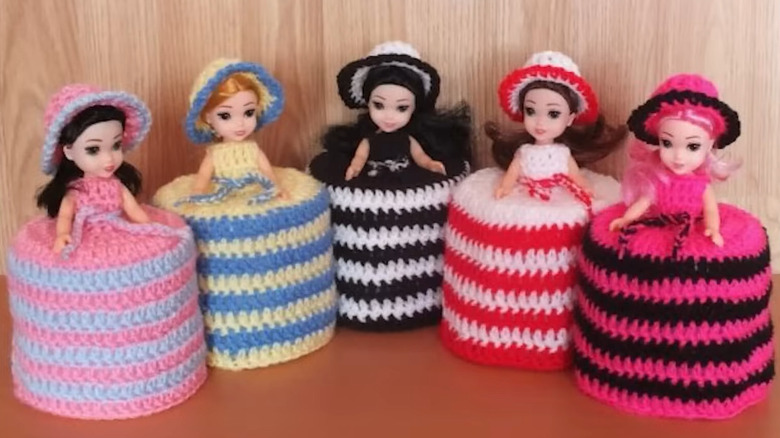 Colorful, crocheted toilet paper dolls