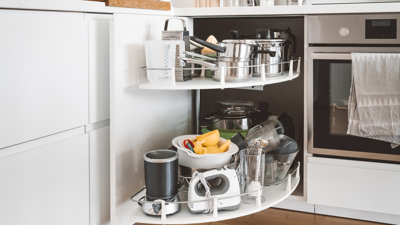 various kitchen items stored in corner cabinet