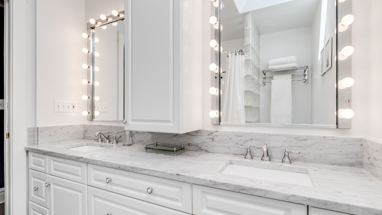 White bathroom with hollywood vanity lights