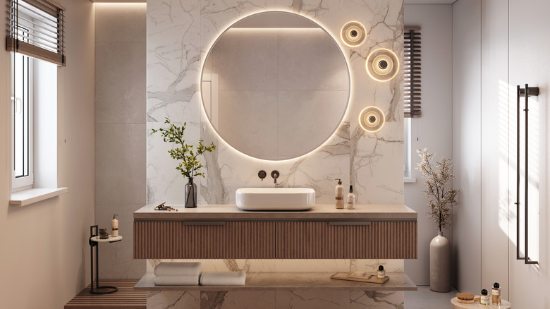 Bathroom with modern vanity and round mirror