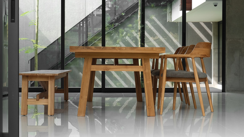 Dining set with bench seating on one side in front of a floor-to-ceiling window