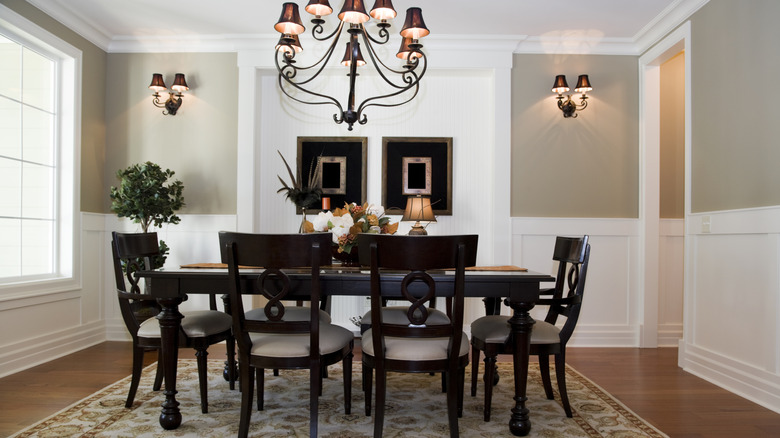 Formal dining room with a dark wood matching dining set and chandelier hanging overhead
