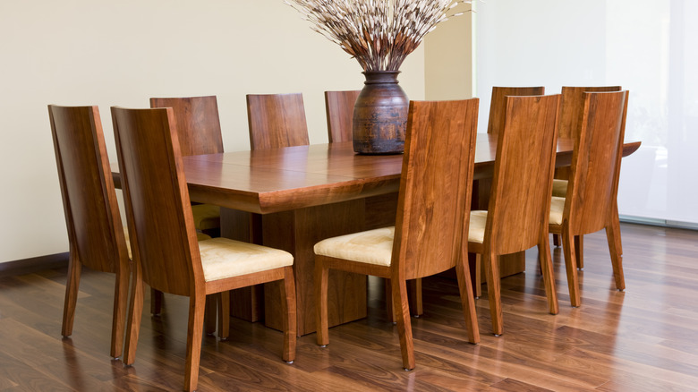 A matching wood dining table with chairs around it