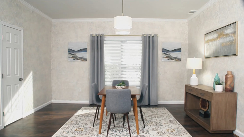 A modern kitchen with an island and a floral accent wall