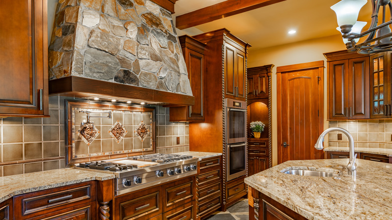 A kitchen with a stone range hood