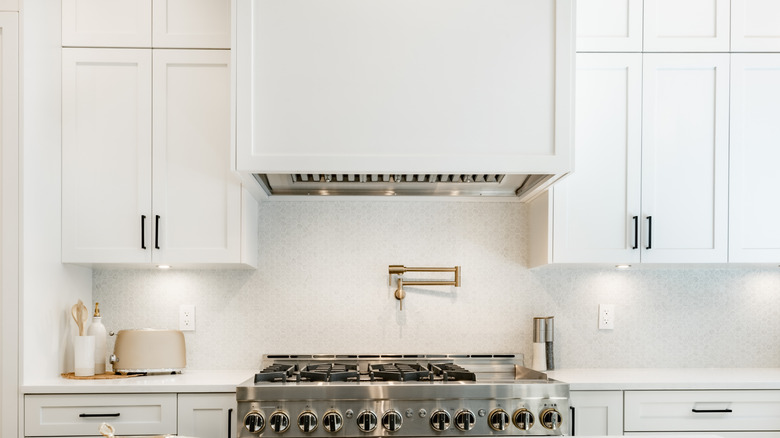 A kitchen with a pot filler over the stove