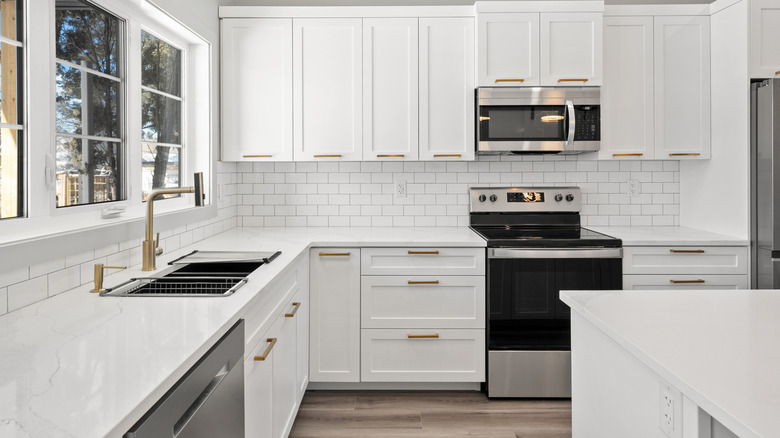 A white kitchen with stainless steel appliances